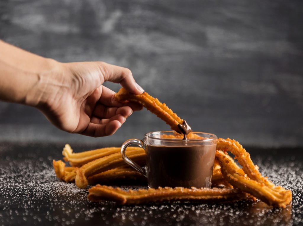 delicious-churros-with-melted-chocolate-table